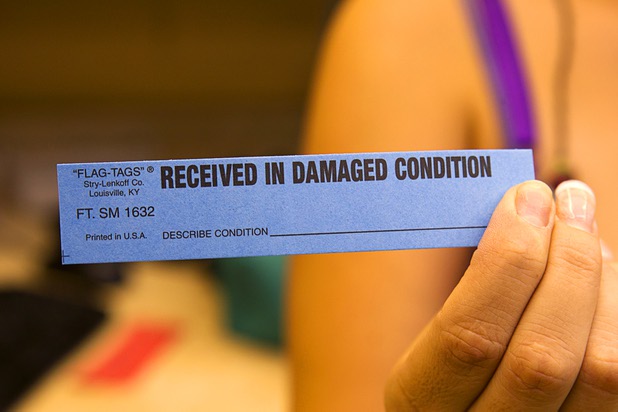 Edith Aguirre displays a paper tag at Tiffany Cleaners in the Commercial Center Monday, Sept. 9, 2013. The tag will be attached to the clothing if there is any pre-existing damage. In addition to serving their normal dry cleaning customers, the shop also provides dry cleaning for most of the shows on the Las Vegas Strip.