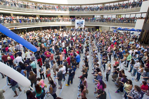 Zappos employees and guests cut a continuous one-mile ribbon during the grand opening ceremony for the Zappos headquarters in the old city hall building downtown Monday, Sept. 9, 2013. According to RecordSetter, a record was set for the largest number of people (1,577 people) to cut a grand opening ribbon at the same time.