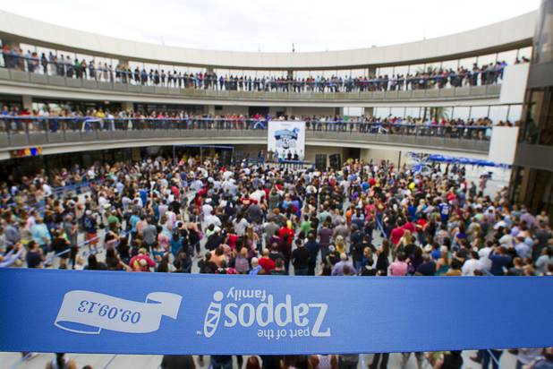 Zappos employees and guests gather for a ribbon-cutting ceremony for the Zappos headquarters in the old city hall building downtown Monday, Sept. 9, 2013. According to RecordSetter, a record was set for the largest number of people (1,577 people) to cut a grand opening ribbon at the same time.