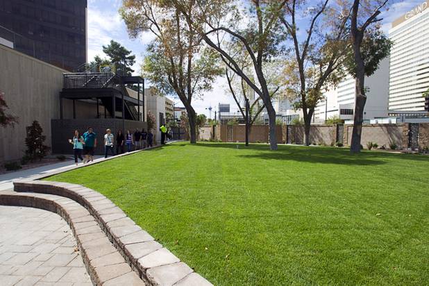 A group passes through the "Backyard" during a tour of the Zappos headquarters in the old city hall building downtown Monday, Sept. 9, 2013. The downtown headquarters officially opened Monday.