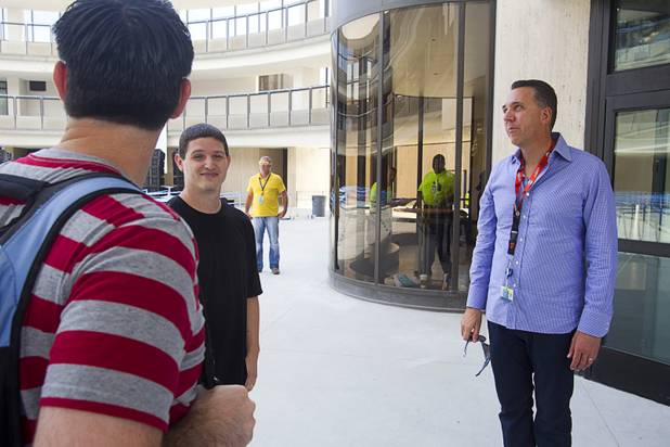 Fred Mossler, right, the first employee of Zappos, looks over the new Zappos headquarters in the old city hall building downtown Monday, Sept. 9, 2013. The downtown headquarters officially opened Monday.