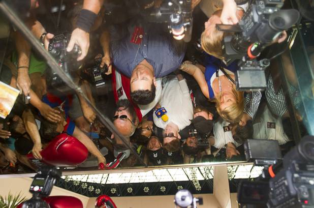 Undefeated boxer Canelo Alvarez of Mexico is reflected in a mirrored ceiling as he arrives at the MGM Grand Tuesday, Sept. 10, 2013. Alvarez will face Floyd Mayweather Jr. in a WBC/WBA 154-pound title fight at the MGM Grand Garden Arena on Saturday.
