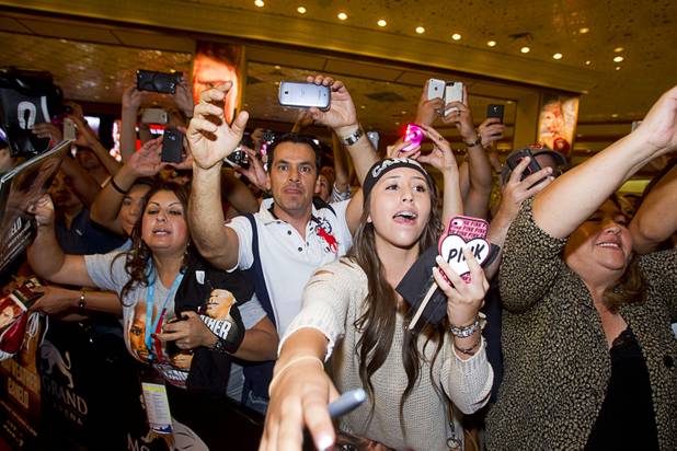 Fans try to get the attention of Canelo Alvarez of Mexico during boxer arrivals at the MGM Grand Tuesday, Sept. 10, 2013. Alvarez will take on Floyd Mayweather Jr. in a WBC/WBA 154-pound title fight at the MGM Grand Garden Arena on Saturday.