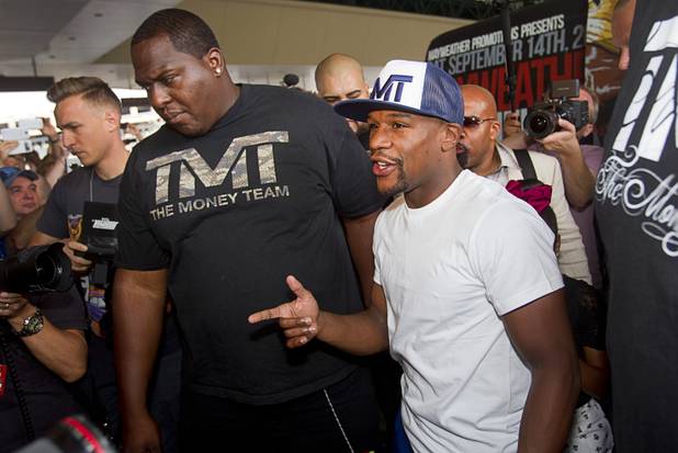 Undefeated boxer Floyd Mayweather Jr. arrives at the MGM Grand Tuesday, Sept. 10, 2013. Mayweather will face Canelo Alvarez of Mexico in a WBC/WBA 154-pound title fight at the MGM Grand Garden Arena on Saturday. Alvarez is also undefeated with one draw. 