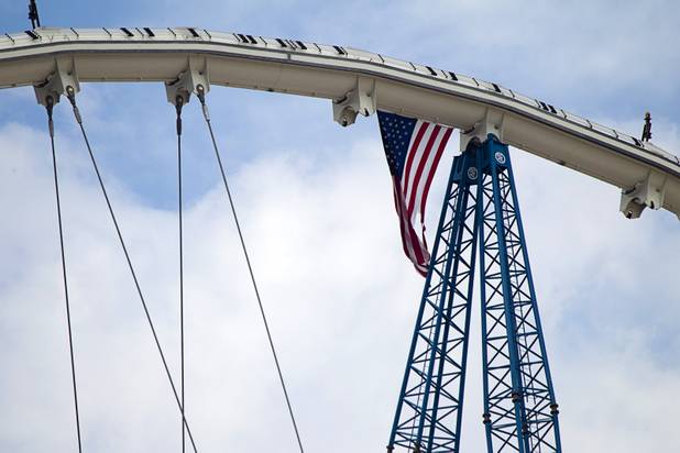 An American flag flies from the High Roller observation wheel under construction Tuesday, September 10, 2013. The final segment of the outer wheel was installed Tuesday. The 550-foot tall observation wheel, which will be the tallest in the world when completed, is the centerpiece of of the $550 million Linq entertainment district being built by Caesars Entertainment Corp.