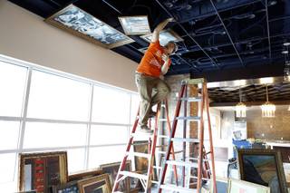 Andy Ruiz of Quality Installation covers the ceiling with paintings at Downtown Grand under construction on Tuesday, September 10, 2013.
