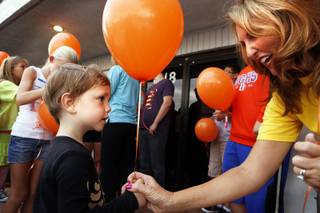 Kelly Thomas-Boyers, the founder of and President of Adam's Place for Grief, gives a balloon to Dov, 3, to write a message to his deceased father for a balloon release at Adam's Place for Grief in Las Vegas on Tuesday, September 10, 2013.