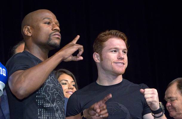 Undefeated boxers Floyd Mayweather Jr., left, and Canelo Alvarez of Mexico pose during a news conference at the MGM Grand Wednesday, Sept. 11, 2013. Mayweather and Alvarez will meet for a WBC/WBA 154-pound title fight at the MGM Grand Garden Arena on Saturday.