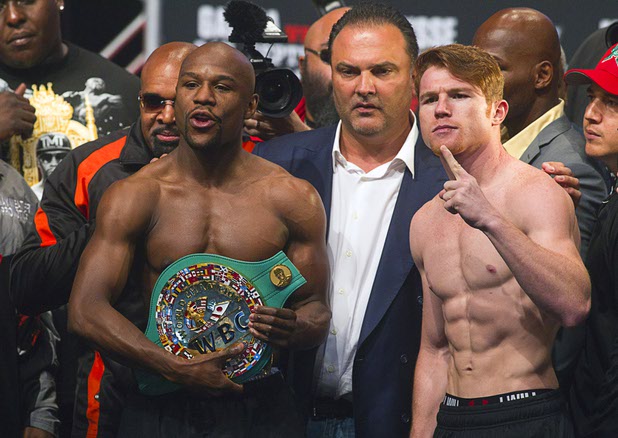 Undefeated boxers Floyd Mayweather Jr., left, and Canelo Alvarez of Mexico pose during an official weigh-in at the MGM Grand Garden Arena Friday Sept. 13, 2013. The boxers will face each other in a WBC/WBA 154-pound title fight at the arena Saturday.