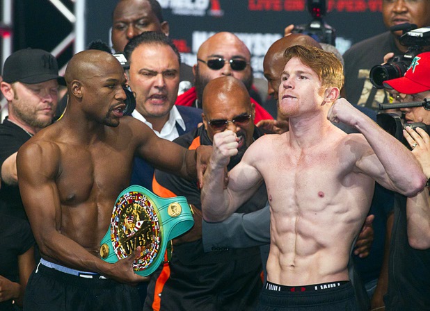 Undefeated boxers Floyd Mayweather Jr., left, and Canelo Alvarez of Mexico pose during an official weigh-in at the MGM Grand Garden Arena Friday Sept. 13, 2013. The boxers will face each other in a WBC/WBA 154-pound title fight at the arena Saturday.
