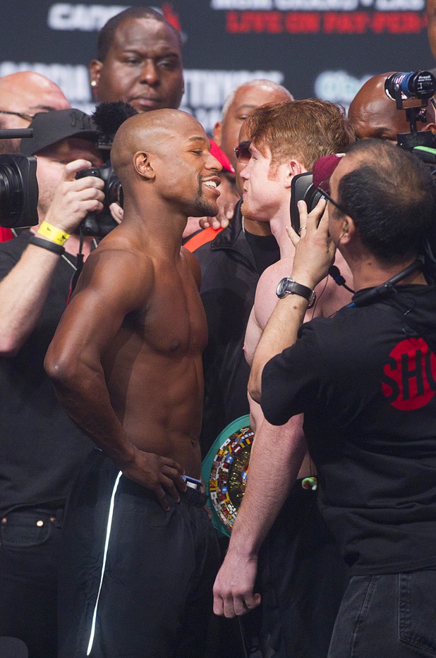 Undefeated boxers Floyd Mayweather Jr., left, and Canelo Alvarez of Mexico face off during an official weigh-in at the MGM Grand Garden Arena Friday Sept. 13, 2013. The boxers will face each other in a WBC/WBA 154-pound title fight at the arena Saturday.