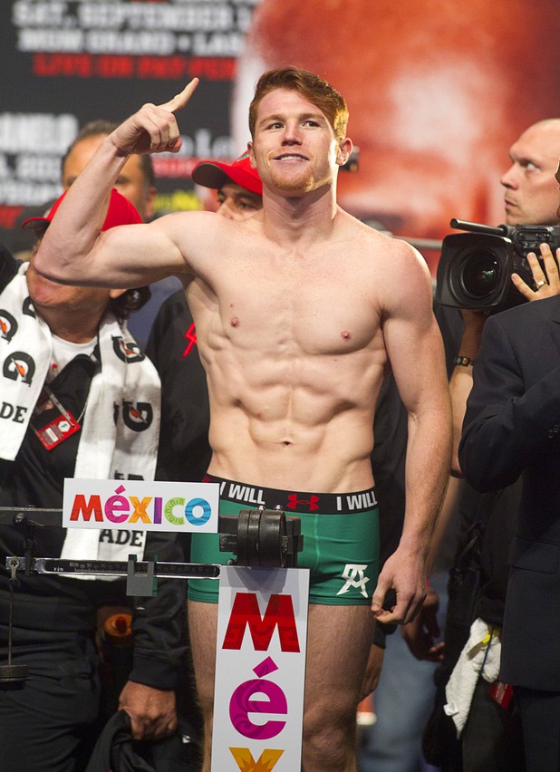 Canelo Alvarez of Mexico poses on the scale during an official weigh-in at the MGM Grand Garden Arena Friday Sept. 13, 2013. Alvarez will face Floyd Mayweather Jr.in a WBC/WBA 154-pound title fight at the arena Saturday.