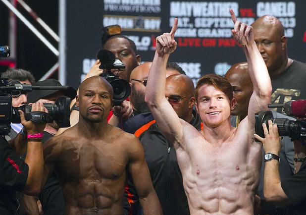 Undefeated boxers Floyd Mayweather Jr., left, and Canelo Alvarez of Mexico pose during an official weigh-in at the MGM Grand Garden Arena Friday Sept. 13, 2013. The boxers will face each other in a WBC/WBA 154-pound title fight at the arena Saturday.