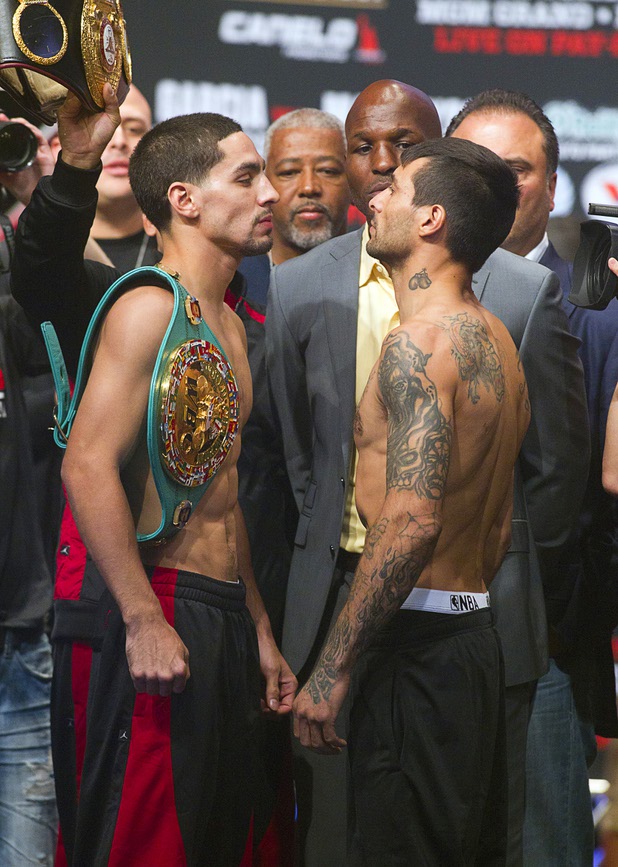 WBC/WBA junior welterweight champion Danny Garcia (L) and Lucas Matthysse of Argentina face off during an official weigh-in at the MGM Grand Garden Arena Friday Sept. 13, 2013. Garcia will defend his titles against Matthysse at the arena Saturday.