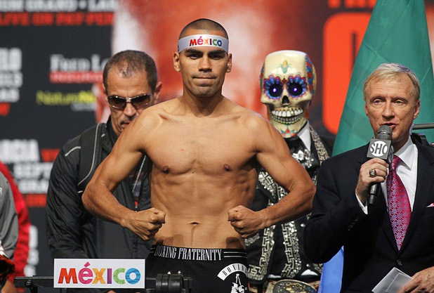 Carlos Molina of Mexico poses on the scale during an official weigh-in at the MGM Grand Garden Arena Friday Sept. 13, 2013. Molina will challenge IBF junior middleweight champion Ishe Smith for the title at the arena Saturday.
