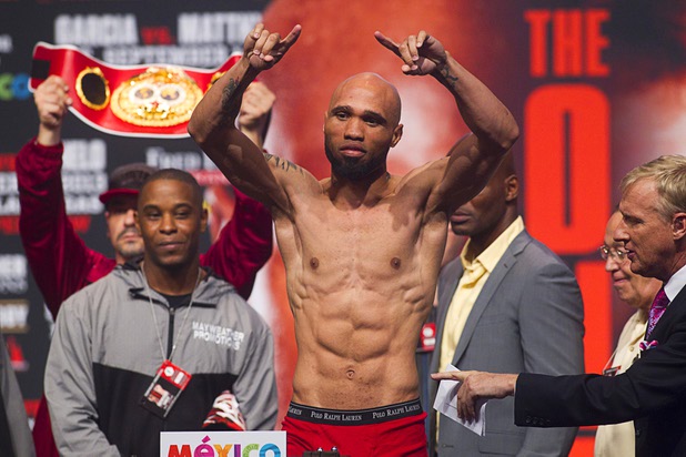 IBF junior middleweight champion Ishe Smith (L) poses on the scale during an official weigh-in at the MGM Grand Garden Arena Friday Sept. 13, 2013. Smith will defend his title against Carlos Molina of Mexico at the arena Saturday.