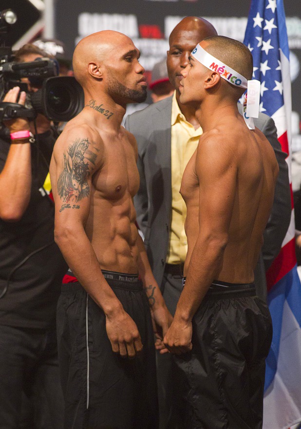 IBF junior middleweight champion Ishe Smith (L) and Carlos Molina of Mexico face off during an official weigh-in at the MGM Grand Garden Arena Friday Sept. 13, 2013. Smith will defend his title against Molina at the arena Saturday.