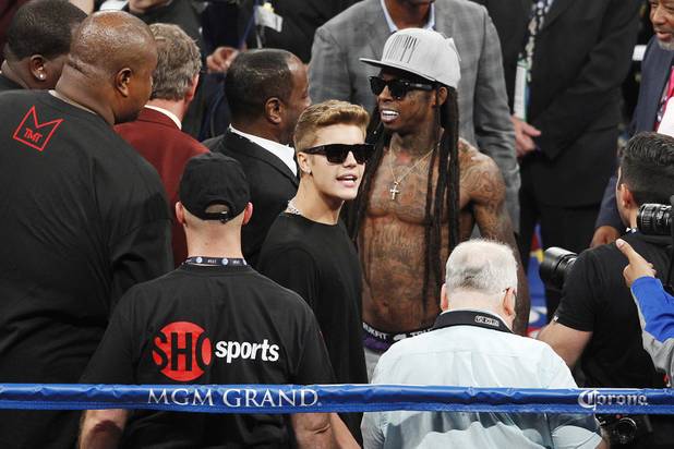 Justin Bieber and Lil' Wayne mill about in the ring before Floyd Mayweather's fight against Canelo Alvarez Saturday, Sept. 14, 2013 at the MGM Grand Garden Arena. Mayweather won the fight with a majority decision.
