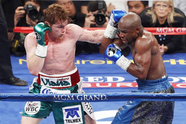 Floyd Mayweather blocks a left from Canelo Alvarez during their super welterweight title fight Saturday, Sept. 14, 2013 at the MGM Grand Garden Arena. Mayweather won the fight with a majority decision.