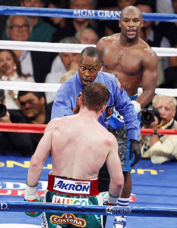 Referee Kenny Bayless warns Canelo Alvarez during his super welterweight title fight against Floyd Mayweather Saturday, Sept. 14, 2013 at the MGM Grand Garden Arena. Mayweather won the fight with a majority decision.