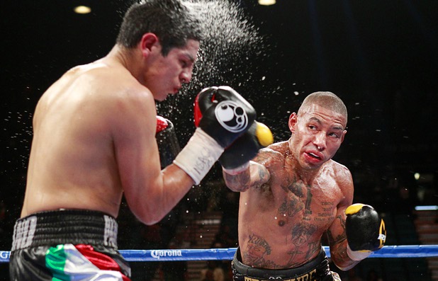 Pablo Cesar Cano, left, of Mexico takes a punch from Ashley Theophane of England during a welterweight fight at the MGM Grand Garden Arena Saturday, Sept. 14, 2013. Cano won the 10-round bout by spit decision.