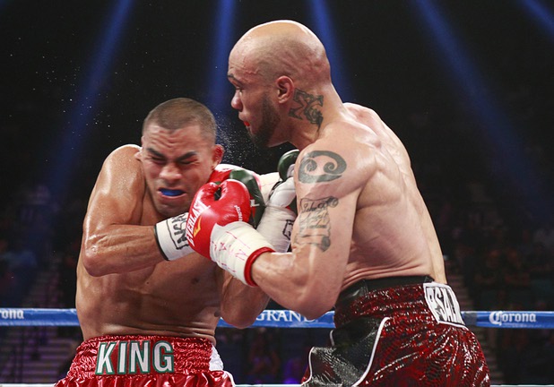 Carlos Molina, left, of Mexico takes a punch from IBF junior middleweight champion Ishe Smith during their title fight at the MGM Grand Garden Arena Saturday, Sept. 14, 2013.