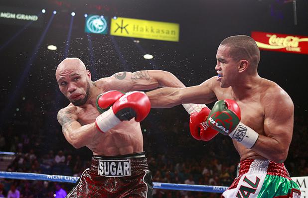 Boxer Carlos Molina, right, of Mexico punches IBF junior middleweight champion Ishe Smith during their title fight at the MGM Grand Garden Arena Saturday, Sept. 14, 2013. Molina took the title with a split decision victory.