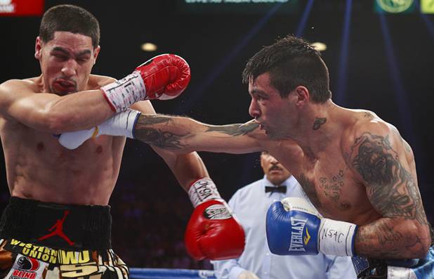 WBC/WBA junior welterweight champion Danny Garcia, left, takes a punch from Lucas Matthysse of Argentina during their title fight at the MGM Grand Garden Arena Saturday, Sept. 14, 2013.