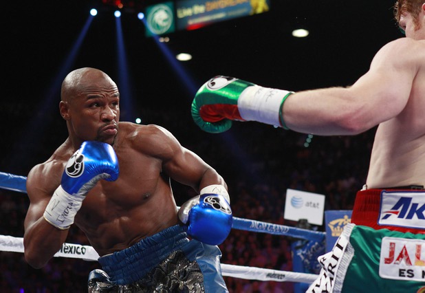 Floyd Mayweather Jr., left, fights WBC/WBA 154-pound champion Canelo Alvarez during their title fight at the MGM Grand Garden Arena Saturday, Sept. 14, 2013.