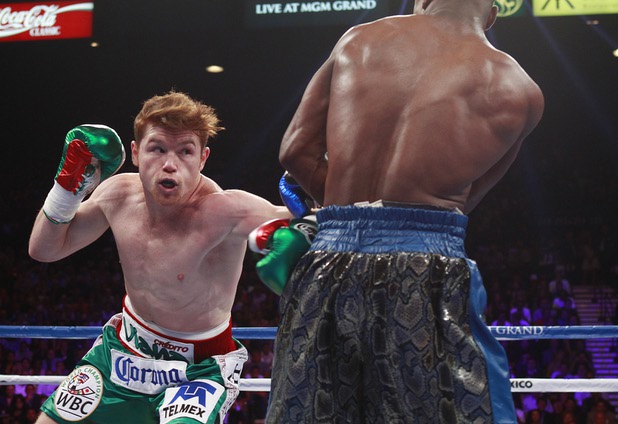 WBC/WBA 154-pound champion Canelo Alvarez, left, fights against Floyd Mayweather Jr. at the MGM Grand Garden Arena Saturday, Sept. 14, 2013.