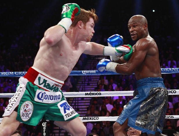 WBC/WBA 154-pound champion Canelo Alvarez, left, fights against Floyd Mayweather Jr. at the MGM Grand Garden Arena Saturday, Sept. 14, 2013.