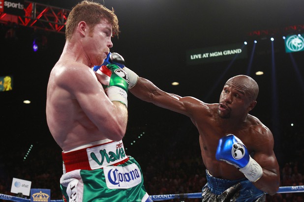 WBC/WBA 154-pound champion Canelo Alvarez, left, avoids a punch from Floyd Mayweather Jr. at the MGM Grand Garden Arena Saturday, Sept. 14, 2013.