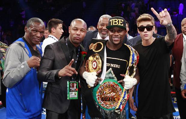 From left: Floyd Mayweather Sr.,  R&B singer Tank, Floyd Mayweather Jr. and Justin Bieber celebrate Floyd Mayweather Jr. victory over WBC/WBA 154-pound champion Canelo Alvarez at the MGM Grand Garden Arena Saturday, Sept. 14, 2013. Alvarez was previously undefeated in 42 fights.