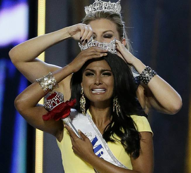 Miss New York Nina Davuluri is crowned 2014 Miss America by 2013 Miss America Mallory Hagan, also of New York, on Sunday, Sept. 15, 2013, in Atlantic City.