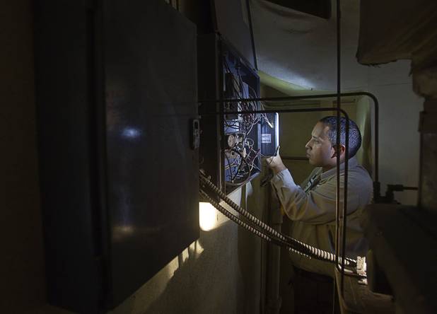 Stephen Molina, an HVAC technician for the Clark County School District, replaces a mechanical timer at Rex Bell Elementary School Tuesday, Sept. 17, 2013. As the effects of the recession continue to affect school operations and deferred maintenance costs continue to rise, the CCSD is finding it difficult to maintain school facilities.