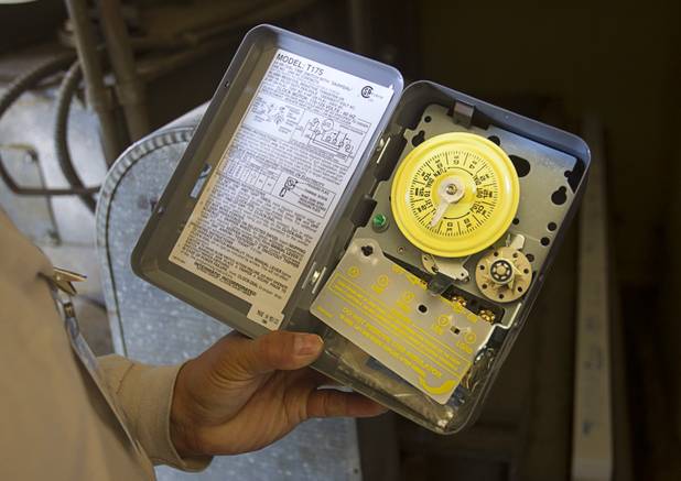 Stephen Molina, an HVAC technician for the Clark County School District, holds a mechanical timer for an air conditioning unit at Rex Bell Elementary School Tuesday, Sept. 17, 2013. As the effects of the recession continue to affect school operations and deferred maintenance costs continue to rise, the CCSD is finding it difficult to maintain school facilities.