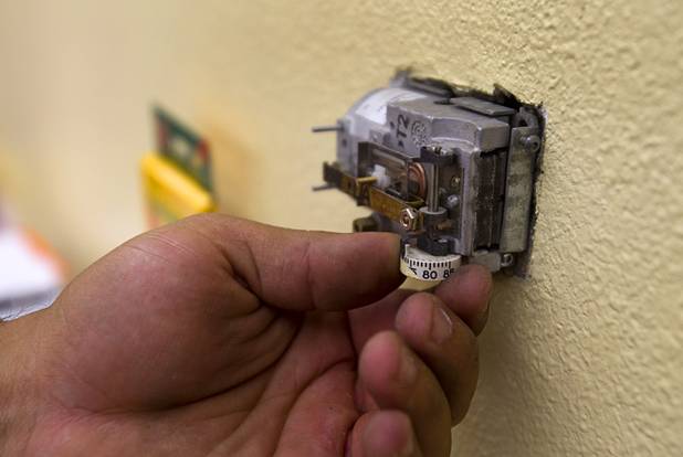 Stephen Molina, an HVAC technicians for the Clark County School District, operates a thermostat at Rex Bell Elementary School Tuesday, Sept. 17, 2013. The old-style thermostats use air pressure to operate the air conditioning units. Turning the dial increases or decreases the pressure.