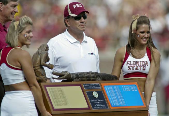 Florida State director of athletics Randy Spetman (far left) and Florida State head coach Jimbo Fisher stand behind cheerleaders holding The Makala Trophy between the first and second quarters of their NCAA spring college football game Saturday, April 14, 2012, in Tallahassee, Fla. The traveling trophy goes to the winner of the annual football game between rivals Florida State and Florida. 