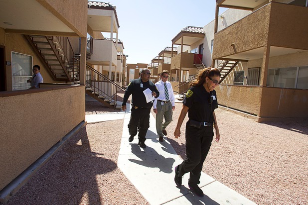 Attendance officer Javier Morales, Rancho High School principal James Kuzma and senior attendance officer Pam Gunter look for a Rancho High School student at an apartment complex Wednesday, September 18, 2013. They later found out that the family had moved.
