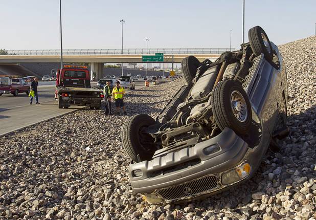 A Mercury Mountaineer SUV is shown on its roof after a rollover accident on I-215 westbound by Windmill Lane Wednesday, Sept. 18, 2013. The use of seat belts kept the occupants from suffering serious injuries, said NHP Trooper Robert Borchardt.  A five year old boy was taken to the hospital to be checked out, he said.