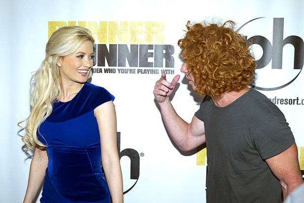 Holly Madison listens to Carrot Top as they arrive for the world premiere of the Twentieth Century Fox and New Regency's film "Runner Runner" at Planet Hollywood Wednesday, September 18, 2013.