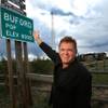 Don Sammons, former owner of the town of Buford, Wyoming, is photographed next to a sign indicating the town's population on September 18, 2013. The town consists of a convenience store, gas station, and modular home on 9.9 acres of land. The town was put up for auction on April 5, 2012, with the highest bid of $900,000 by Vietnamese entrepreneur Pham Dinh Nguyen.