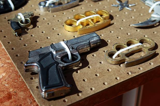 A replica handgun and brass knuckles are shown in a display of confiscated weapons and prohibited items at the Regional Justice Center Thursday, September 19, 2013.