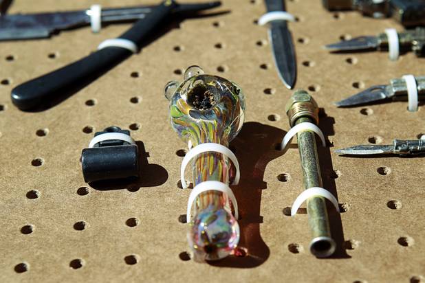 A marijuana pipe with a substance in the bowl is shown in a display of confiscated weapons and prohibited items at the Regional Justice Center Thursday, September 19, 2013. While pipes are not illegal, it's probably not a good idea to bring it to the courthouse.