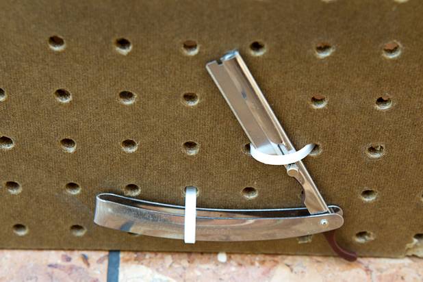 A straight razor is shown in a display of confiscated weapons and prohibited items at the Regional Justice Center Thursday, September 19, 2013.