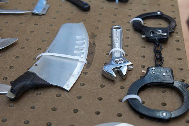 Tools and handcuffs are among a display of confiscated weapons and prohibited items at the Regional Justice Center Thursday, September 19, 2013.