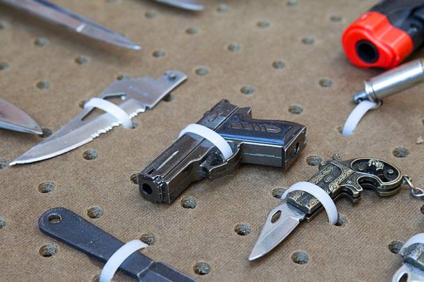 A replica handgun is shown in a display of confiscated weapons and prohibited items at the Regional Justice Center Thursday, September 19, 2013. This gun is actually a lighter.