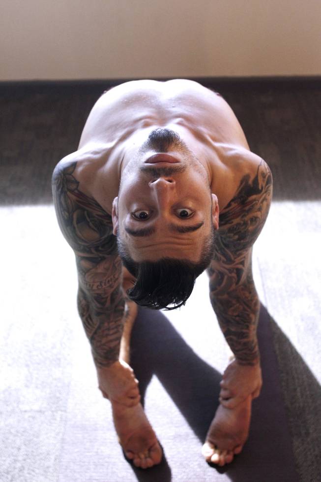 Mixed martial artist Dan Hardy demonstrates yoga poses Thursday, Sept. 19, 2013.