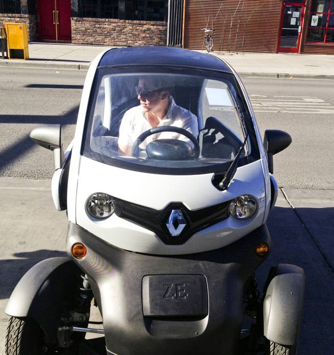 The Twizy, a Renault-made all-electric vehicle, is being tested by Downtown Project to see if it might fit with the Project's planned multi-model transportation system. Andy Chatham demonstrates the vehicle, Thursday, Sept. 19, 2013.