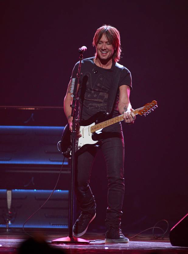 Keith Urban performs during the iHeartRadio Music Festival at the MGM Grand Garden Arena Friday, Sept. 20, 2013.